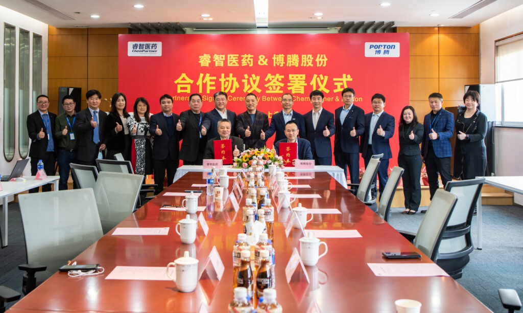 A group of people sitting around a table in a conference room.