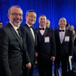 A group of men in tuxedos posing for a photo.