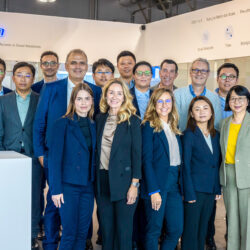 A group of 17 individuals in formal attire poses indoors against a white backdrop, with "PORTON" prominently displayed behind them. This gathering highlights Porton Pharma Solutions' commitment to excellence in the CDMO industry during the CPHI Europe Review.