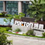 The building exterior showcases a landscaped garden, reflecting Porton's commitment to sustainable development, with a prominent sign displaying "PORTON" in large letters.