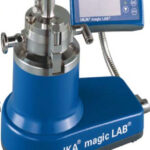 IKA Magic LAB device, blue base, silver fittings, with a digital control panel displaying options. Used for laboratory applications.