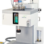 Laboratory reactor system with a digital display, hoses, and containers, used for chemical and process development.