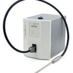 A white gas analyzer device with a digital display and a long attached probe. The probe is connected via a flexible cable.