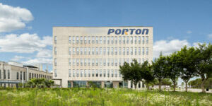 A large building with a grassy field in front of it.