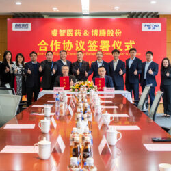 A group of people sitting around a table in a conference room.