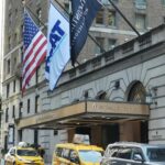 A group of taxi cabs parked in front of a building.